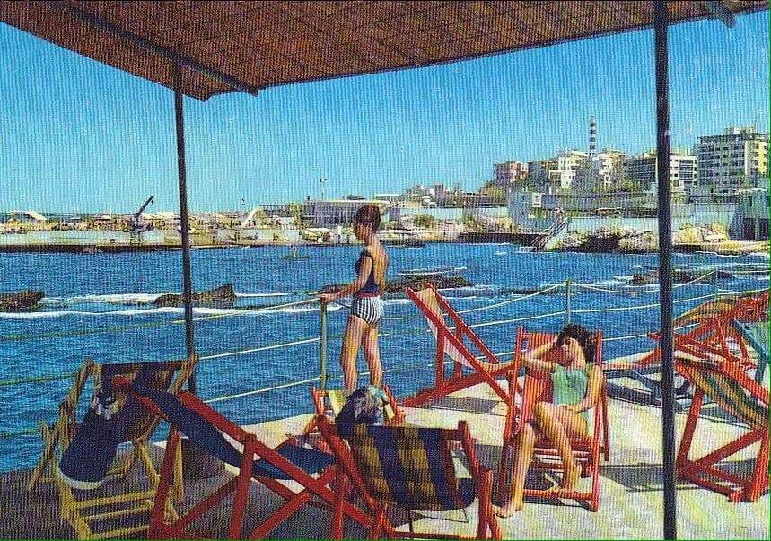 On a shaded deck above the sea at Sporting Club Beach — an archive postcard