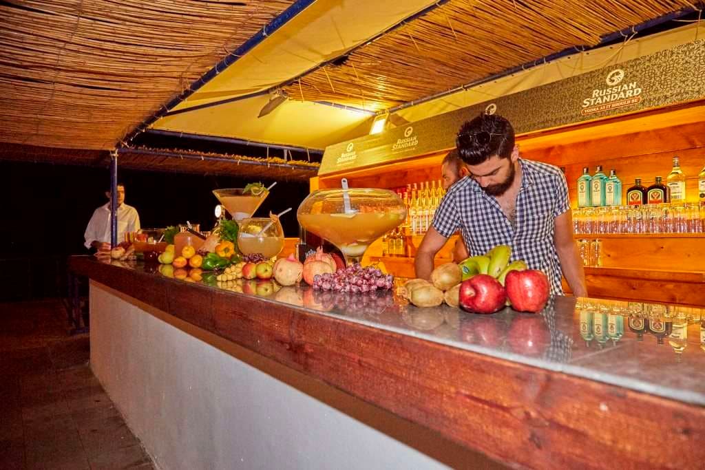 An evening event bar at Sporting Club Beach, cocktails and fresh fruit on the counter
