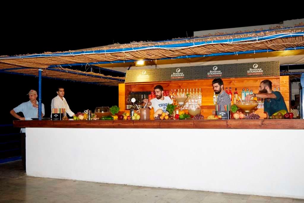 Bartenders at an evening event bar at Sporting Club Beach
