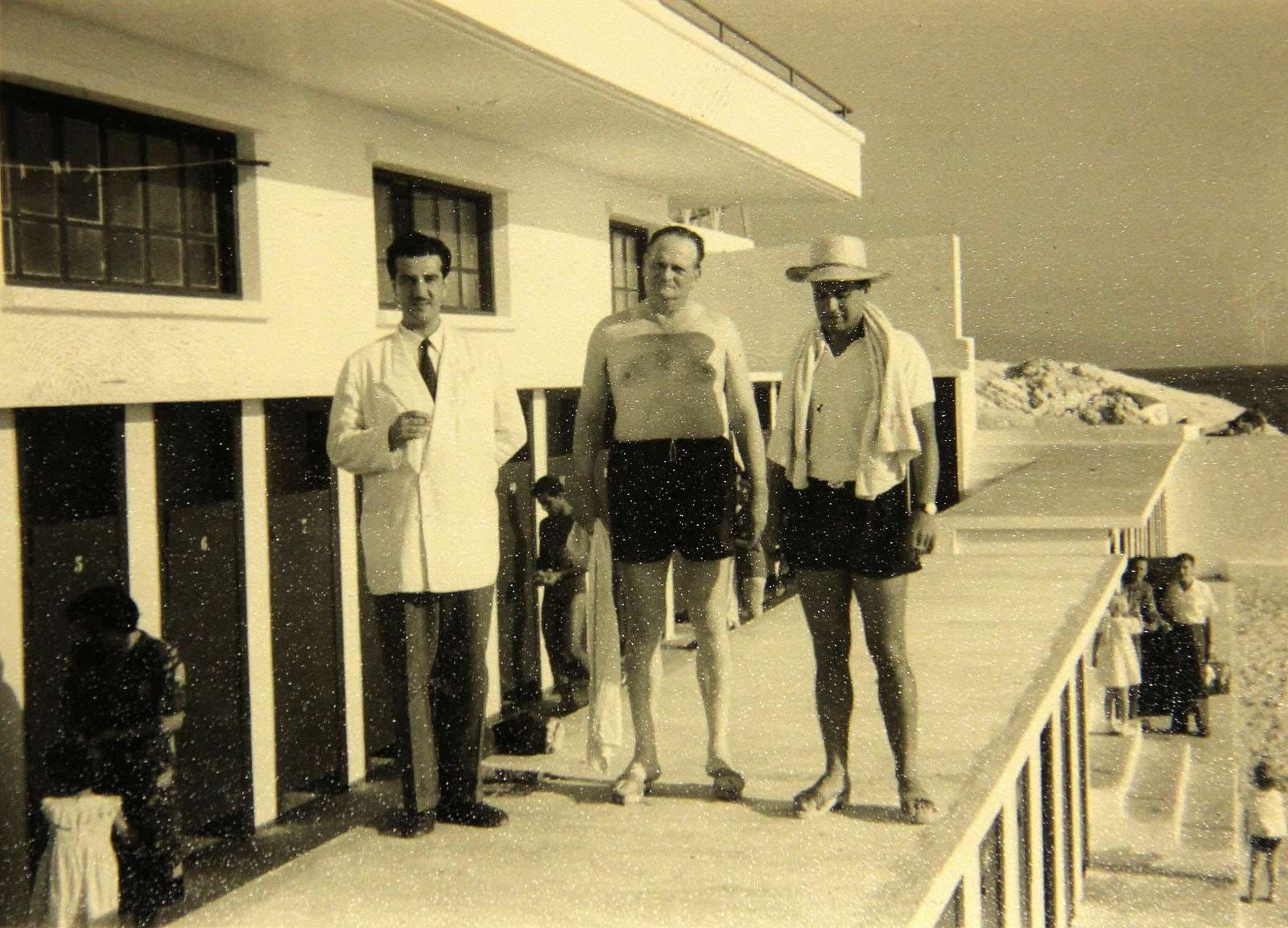 Three men on the cabana terrace at Sporting Club Beach — an archive photograph