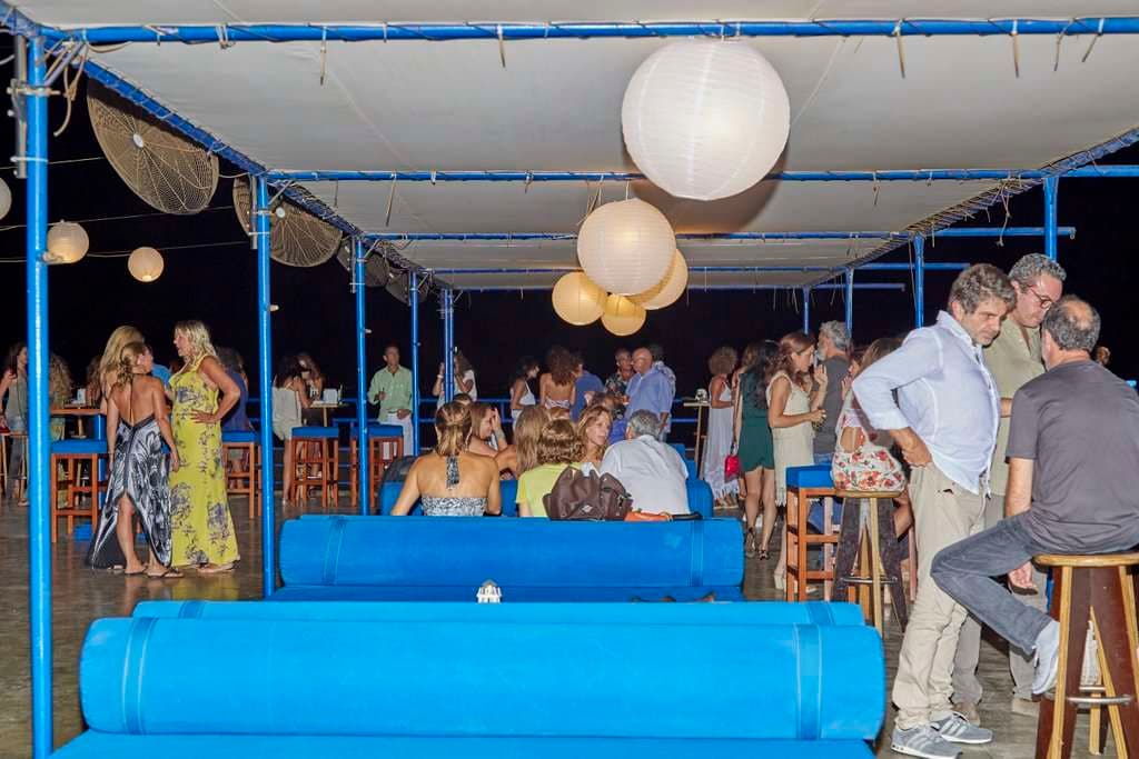 An evening lounge event at Sporting Club Beach, lanterns above the daybeds