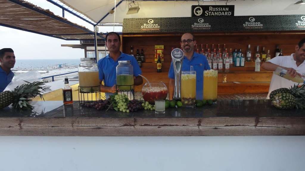 A daytime event bar at Sporting Club Beach, fresh-fruit sangria on the counter
