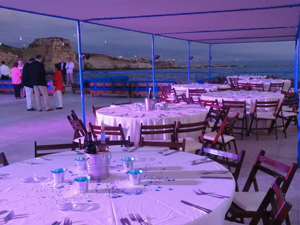 An evening banquet on the terrace at Sporting Club Beach, round tables under the canopy