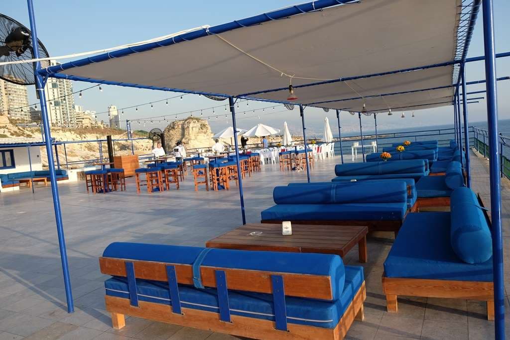 The event terrace at Sporting Club Beach set with daybeds and high tables