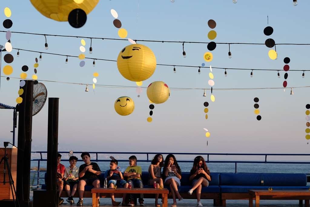A children's party set up at Sporting Club Beach, a photo wall and balloons