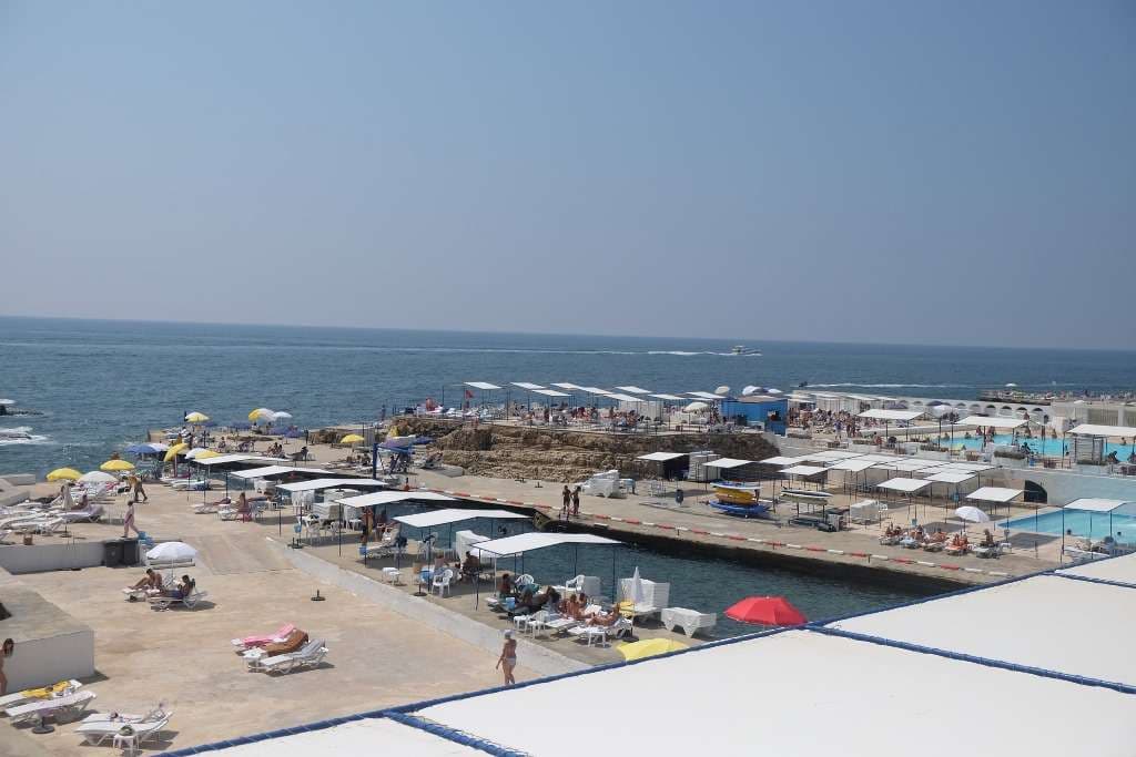 Sunbathers on the seaside terraces beside the saltwater pools at Sporting Club Beach, Ras Beirut