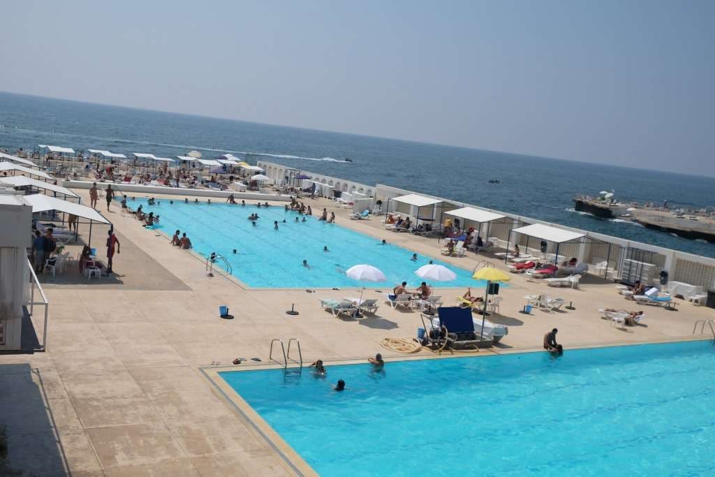 A long saltwater pool along the deck at Sporting Club Beach, the coastline beyond