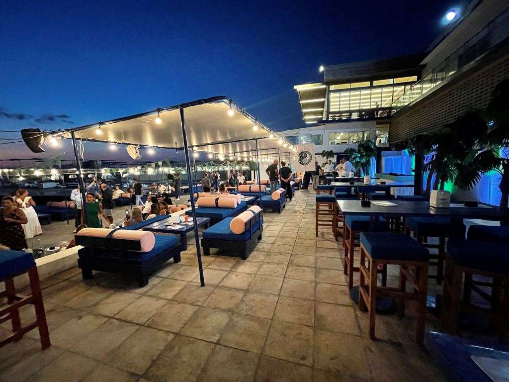 The Loft set with daybeds and bar tables at dusk at Sporting Club Beach, Ras Beirut