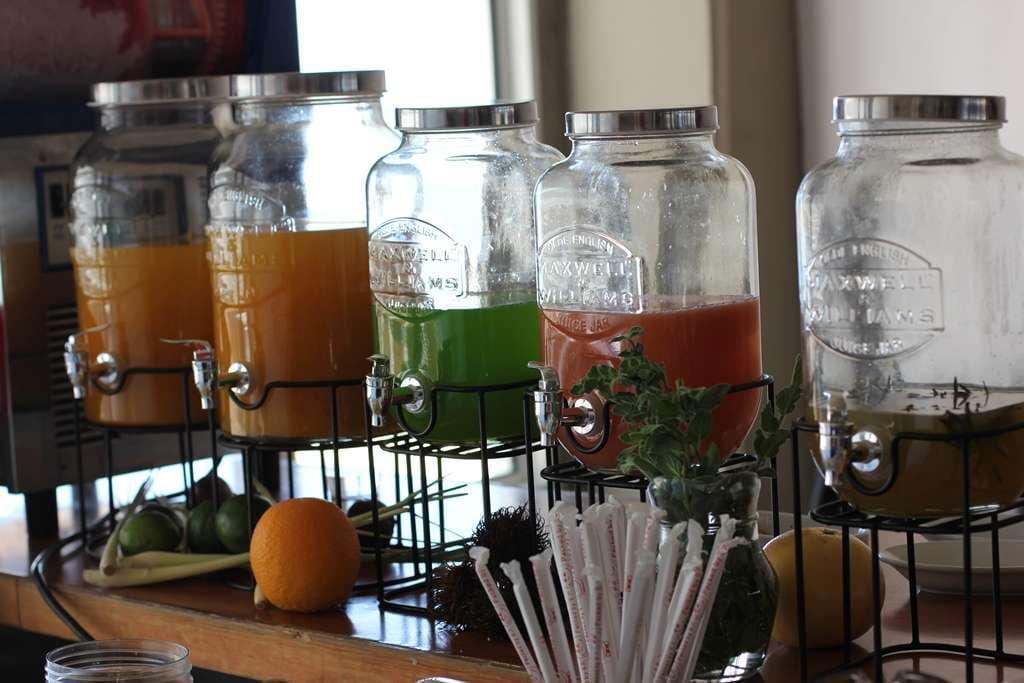 Glass dispensers of fresh juices set out on a bar counter at Sporting Club Beach, Ras Beirut
