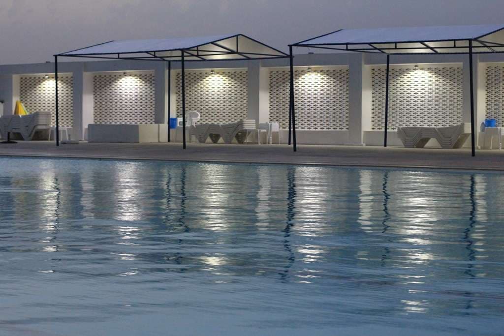 Swimmers and loungers on the pool deck at Sporting Club Beach