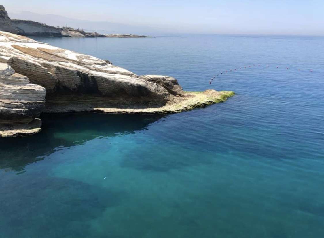 Clear turquoise water in a rocky cove at Sporting Club Beach