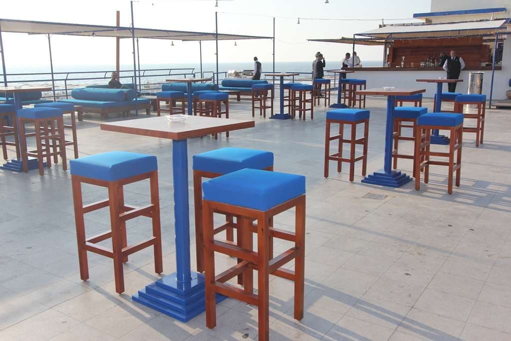 The Loft set with stools, daybeds and high tables above the sea at Sporting Club Beach, Ras Beirut