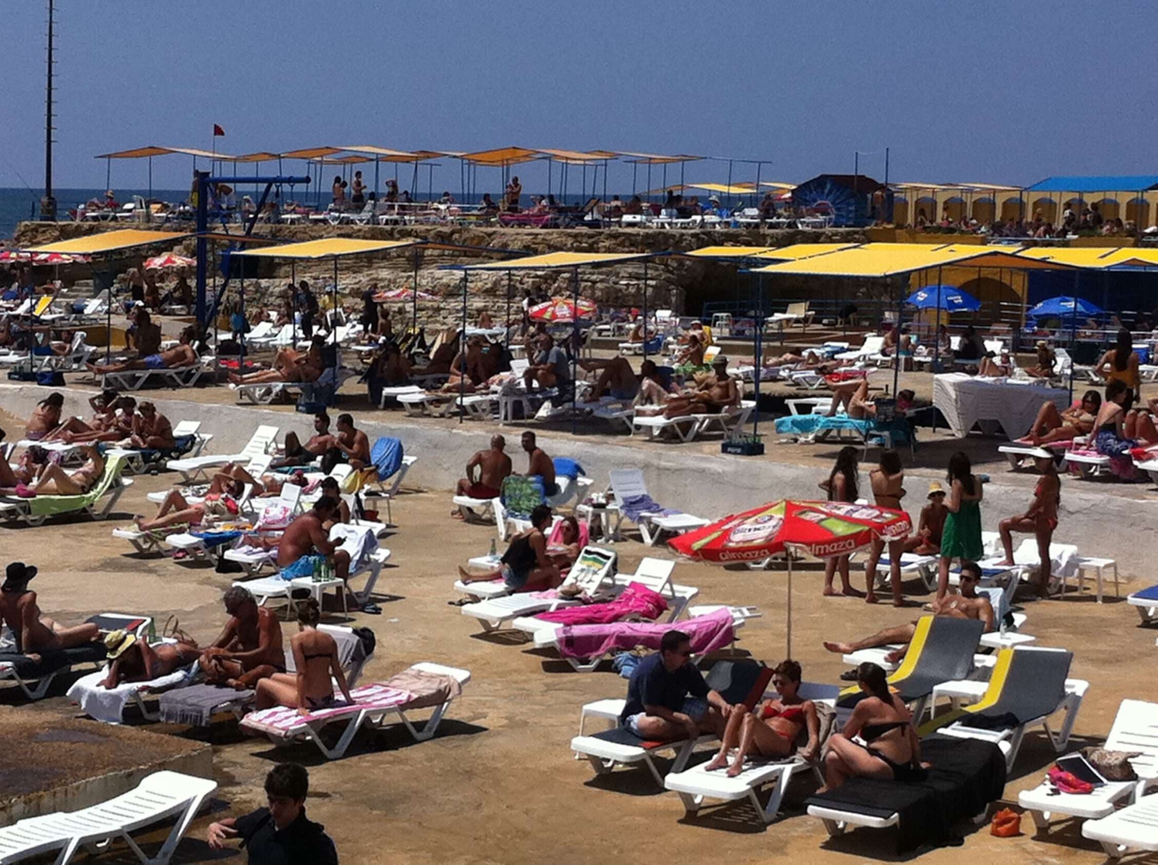 The rocky Ras Beirut shoreline and the Mediterranean at Sporting Club Beach