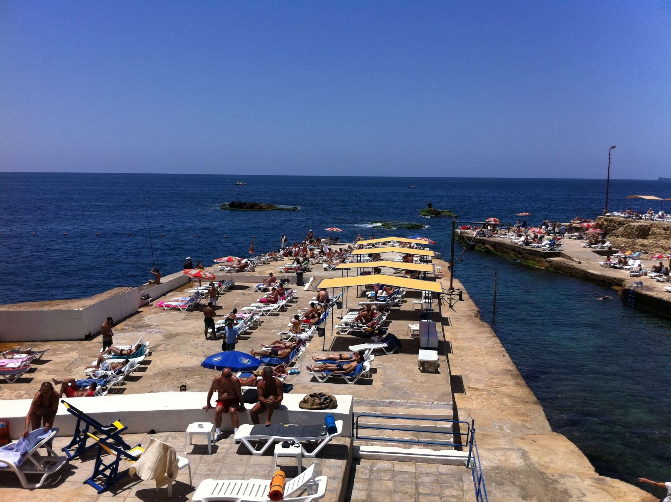 The pools, decks, and rocky coastline at Sporting Club Beach