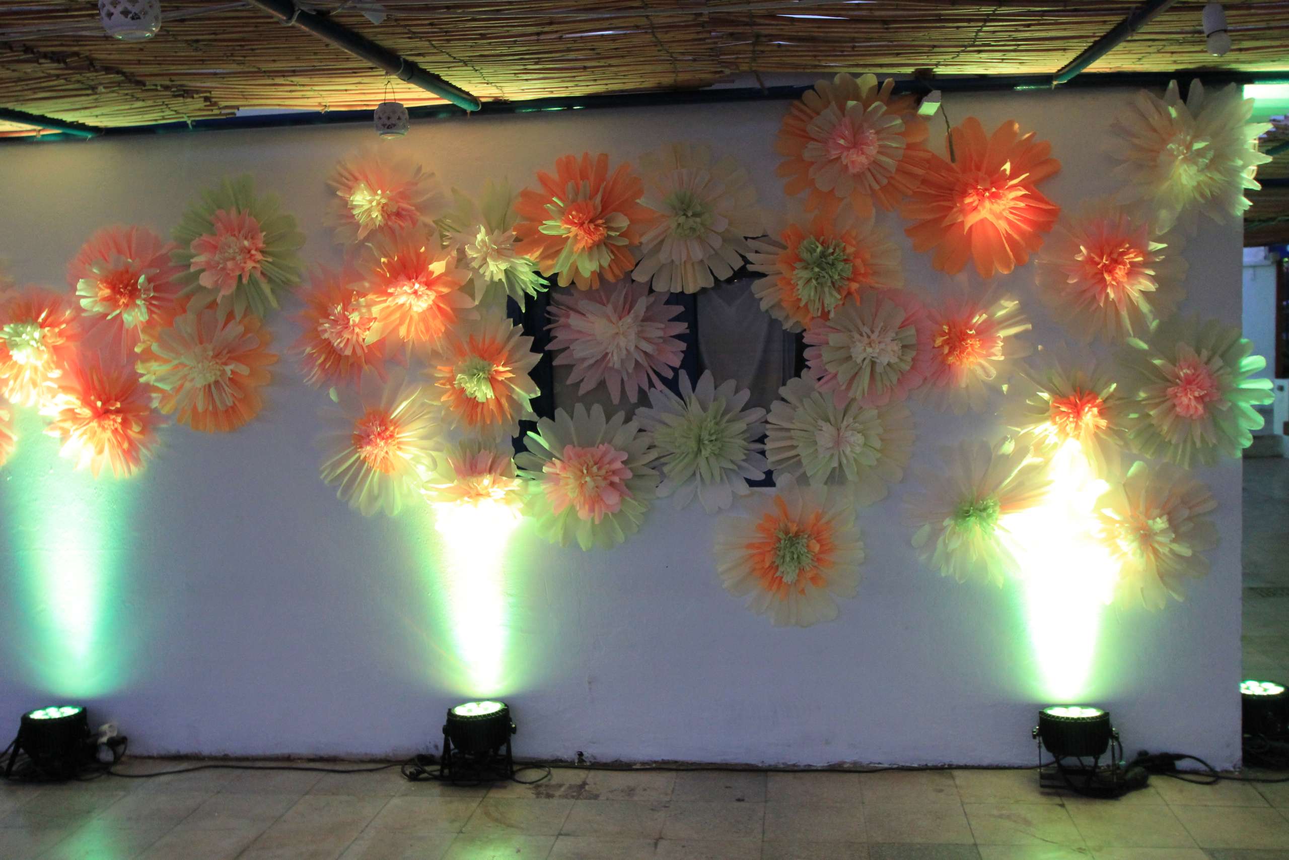 Long banquet tables with sunflower centrepieces set for an event beside the sea at Sporting Club Beach, Ras Beirut