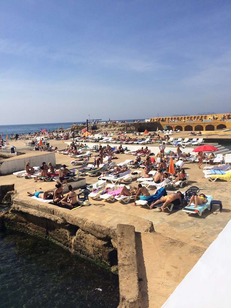 Sunbathers on the seafront deck terraces at Sporting Club Beach in Ras Beirut