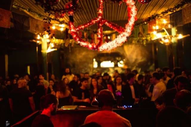 A night crowd before the DJ booth at The Loft by Sporting, Sporting Club Beach