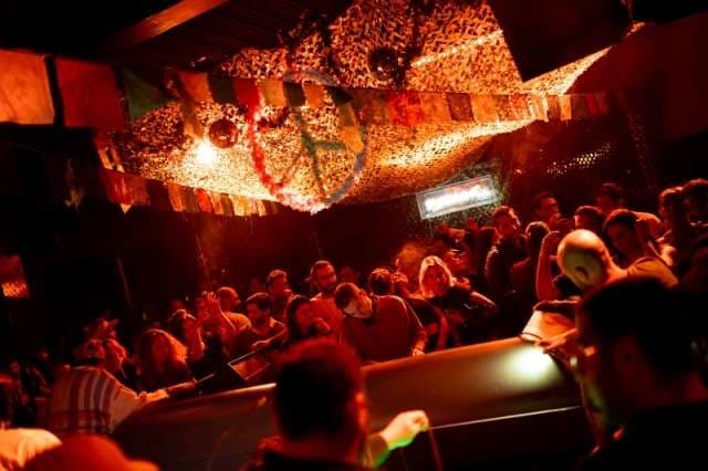 Guests dancing under draped lights at The Loft by Sporting, Sporting Club Beach