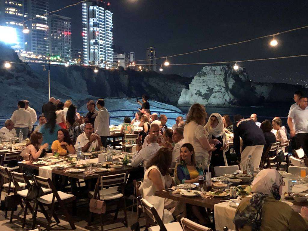A shaded terrace with sofas and tables overlooking the sea at Sporting Club Beach, Ras Beirut