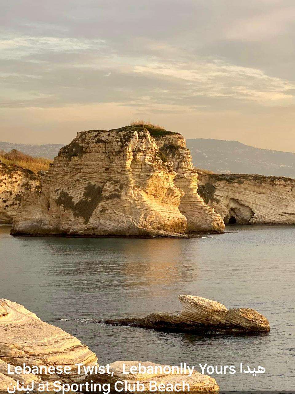 Rock formations rising from the sea at sunset along the coastline at Sporting Club Beach, Ras Beirut
