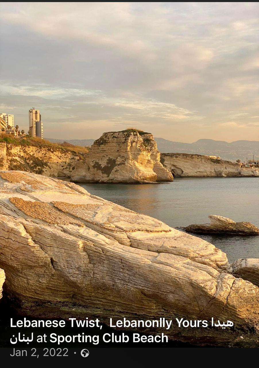 Rocky ledges and the Pigeon Rocks at golden hour along the coastline at Sporting Club Beach, Ras Beirut