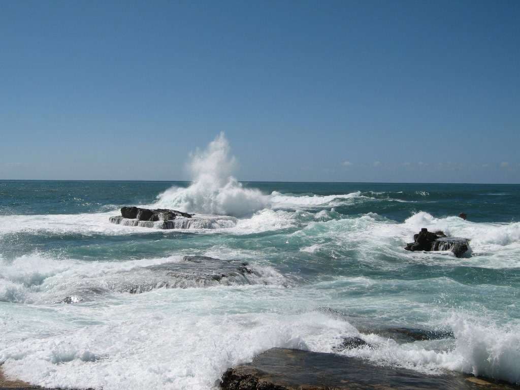 Waves breaking over the rocks at Sporting Club Beach