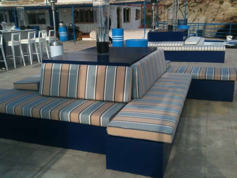 Striped lounge seating and a bar set up on the terrace at Sporting Club Beach, Ras Beirut