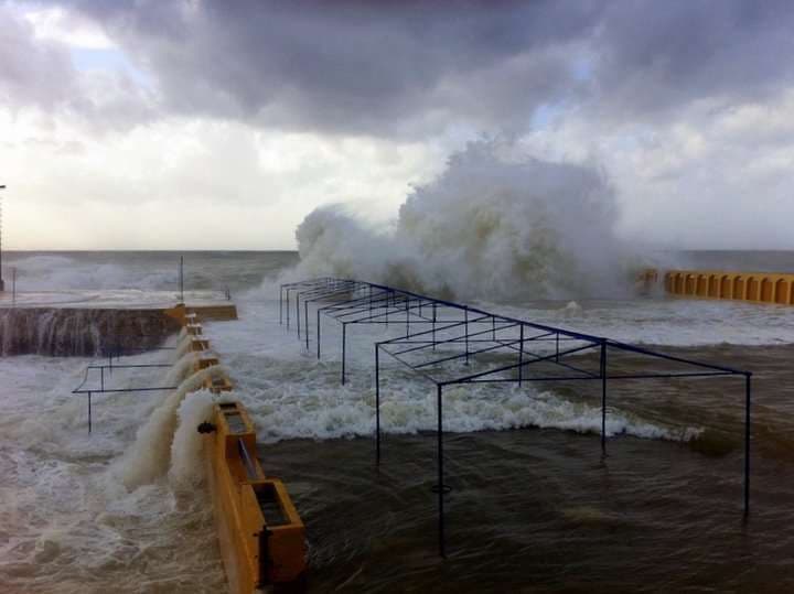 Storm waves crashing over the seafront deck at Sporting Club Beach, Ras Beirut