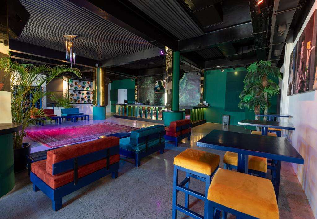 The Loft indoor lounge with green walls, velvet seating and potted palms at Sporting Club Beach, Ras Beirut