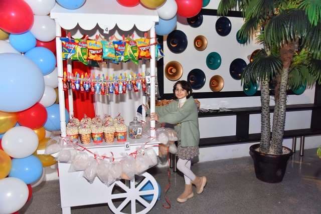 A child at a snack cart during a party inside The Loft at Sporting Club Beach