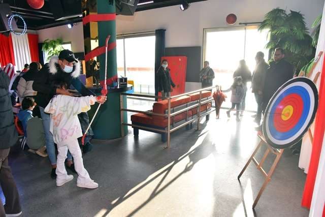Children at an archery game during a party inside The Loft at Sporting Club Beach