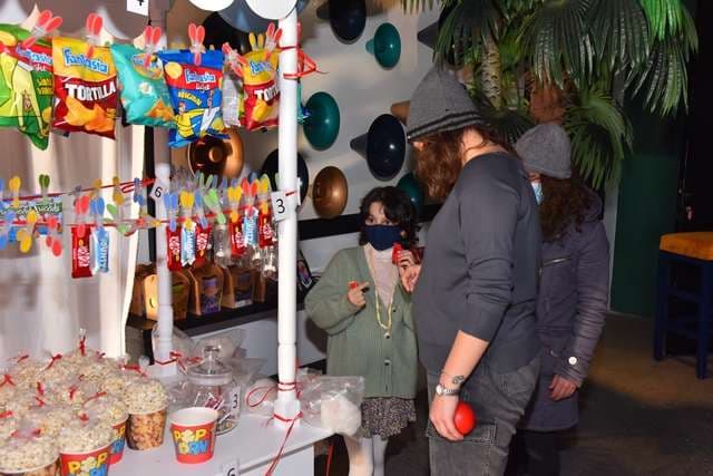 Guests at a snack stall during a party inside The Loft at Sporting Club Beach
