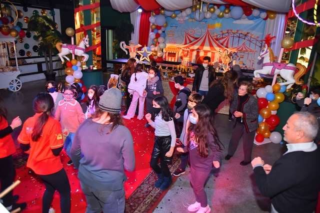 Children dancing during a circus-themed party inside The Loft at Sporting Club Beach