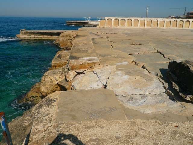 The rocky coastline and stone terraces along the Ras Beirut shore at Sporting Club Beach