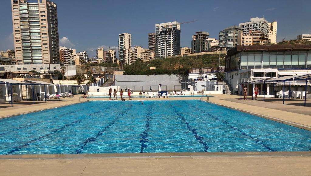 The large saltwater pool with the Beirut skyline behind at Sporting Club Beach