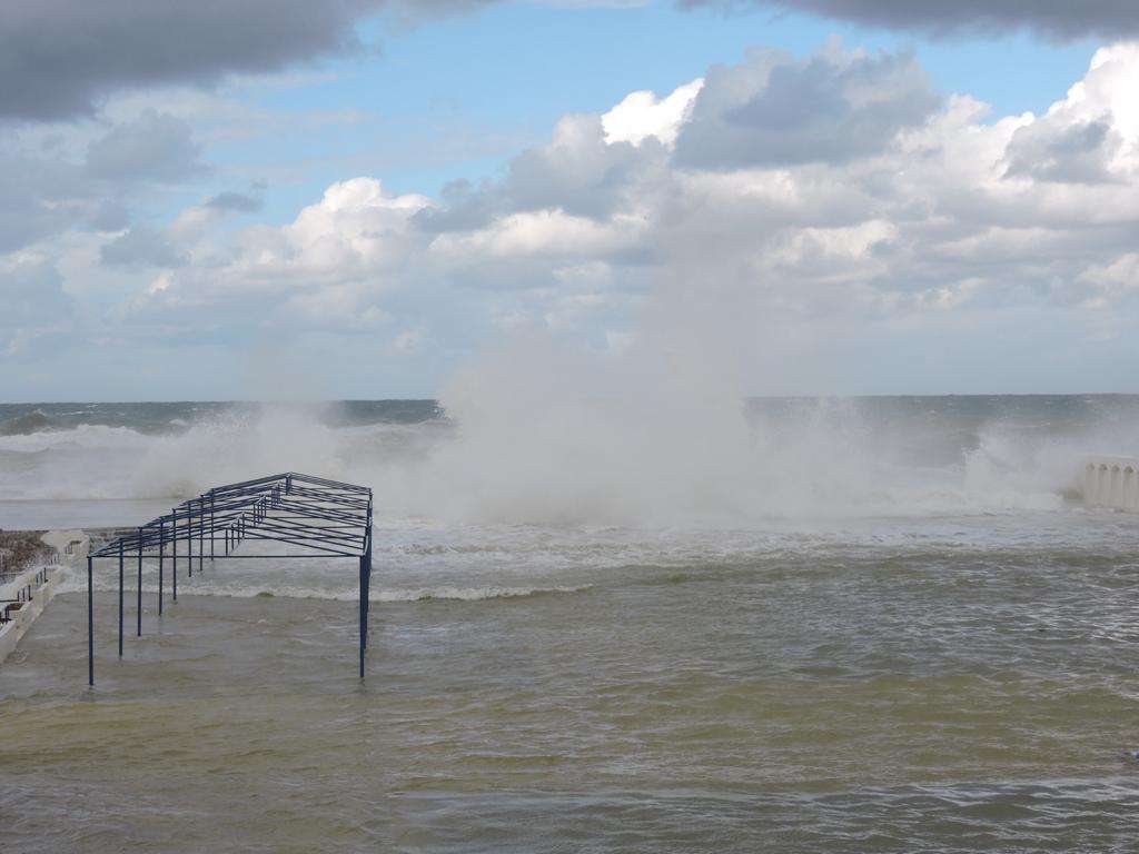 Winter swell breaking over the seafront deck at Sporting Club Beach, Ras Beirut