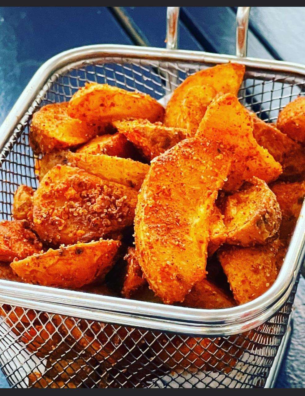 A basket of spiced potato wedges at Sporting Club Beach