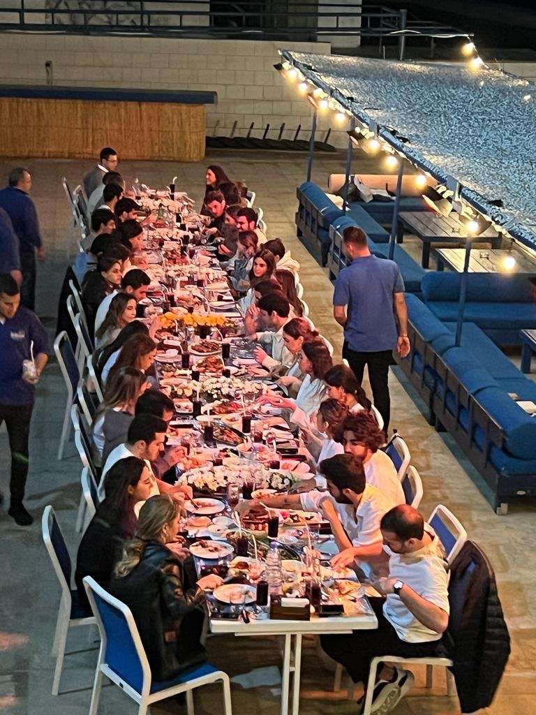 A long seated dinner along the seafront terrace in the evening at Sporting Club Beach