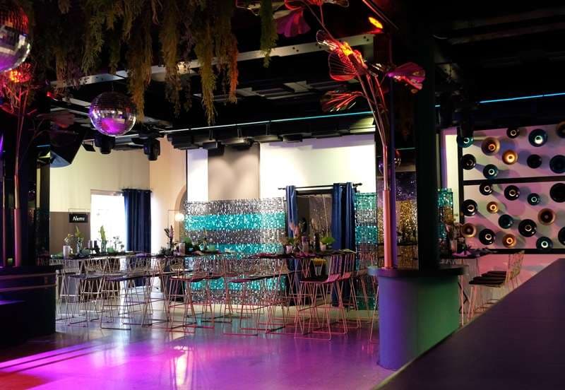 The bar and high tables in The Loft at Sporting Club Beach