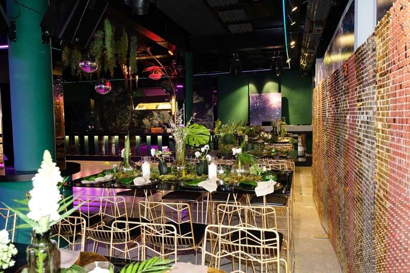 Set dining tables along the sequin wall in The Loft at Sporting Club Beach