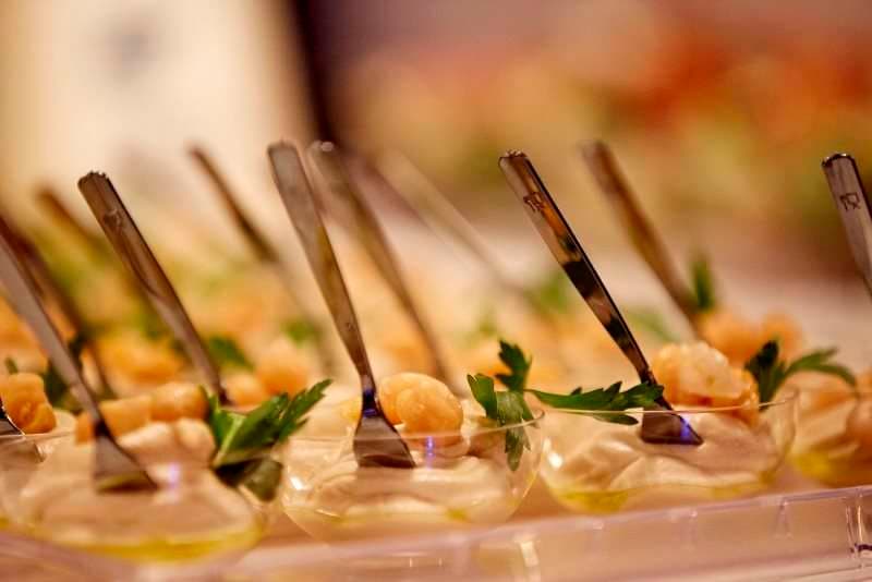 Spoon canapés topped with cream and parsley at Sporting Club Beach