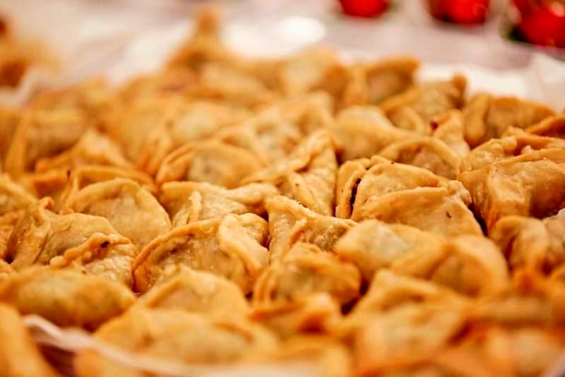 A tray of fried stuffed pastries at Sporting Club Beach