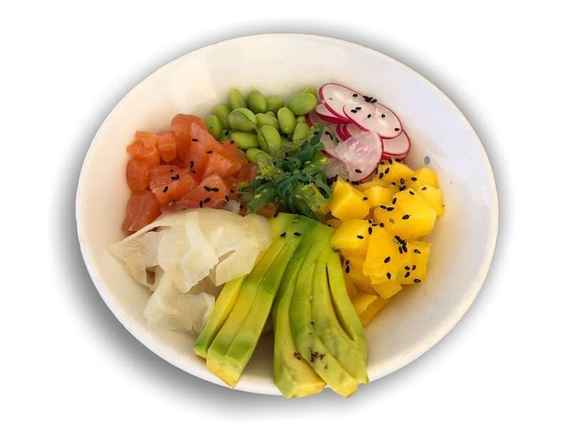 A salmon poke bowl with avocado and mango at Sporting Club Beach