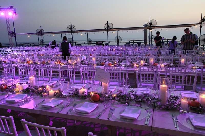 An indoor evening banquet set with round tables at The Loft, Sporting Club Beach
