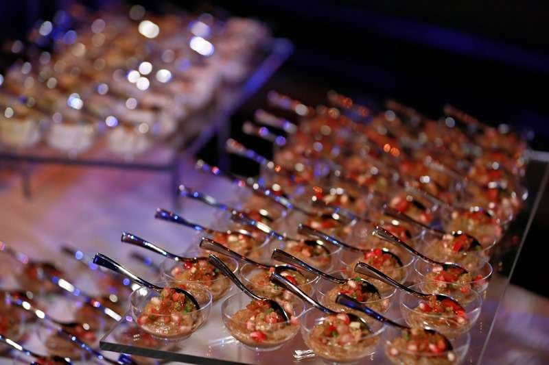 Chopped salad in individual clear party cups with spoons at Sporting Club Beach