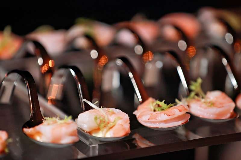 Shrimp served on individual tasting spoons at Sporting Club Beach