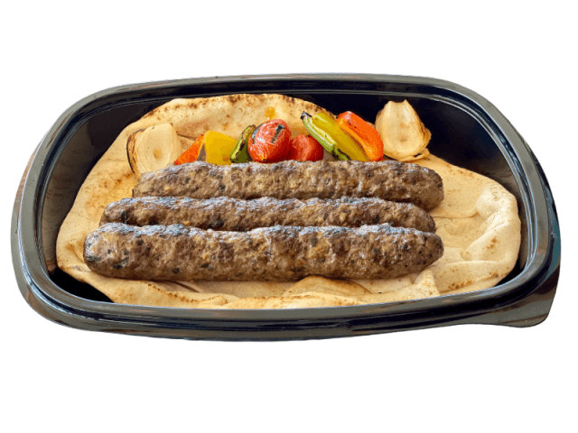 Grilled kafta kabab over flatbread at Sporting Club Beach