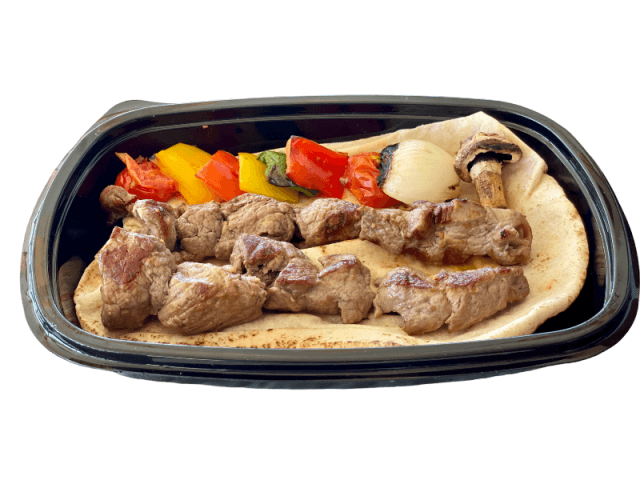 Grilled lamb filet skewers over flatbread at Sporting Club Beach