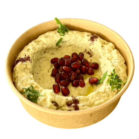 A bowl of moutabal topped with pomegranate at Sporting Club Beach