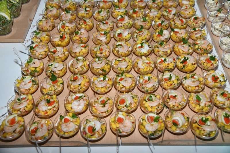 Rows of shrimp cocktail cups laid out for service at Sporting Club Beach